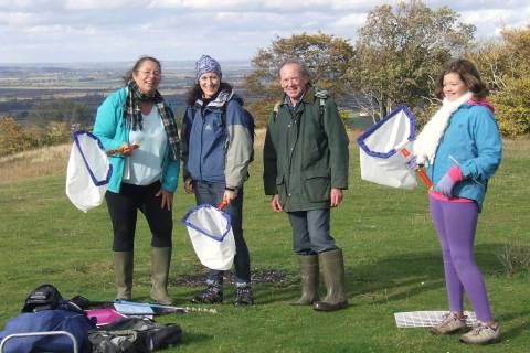 A group performing a biodiversity survey ahead of a quarry clean-up at Whitleaf Hill.